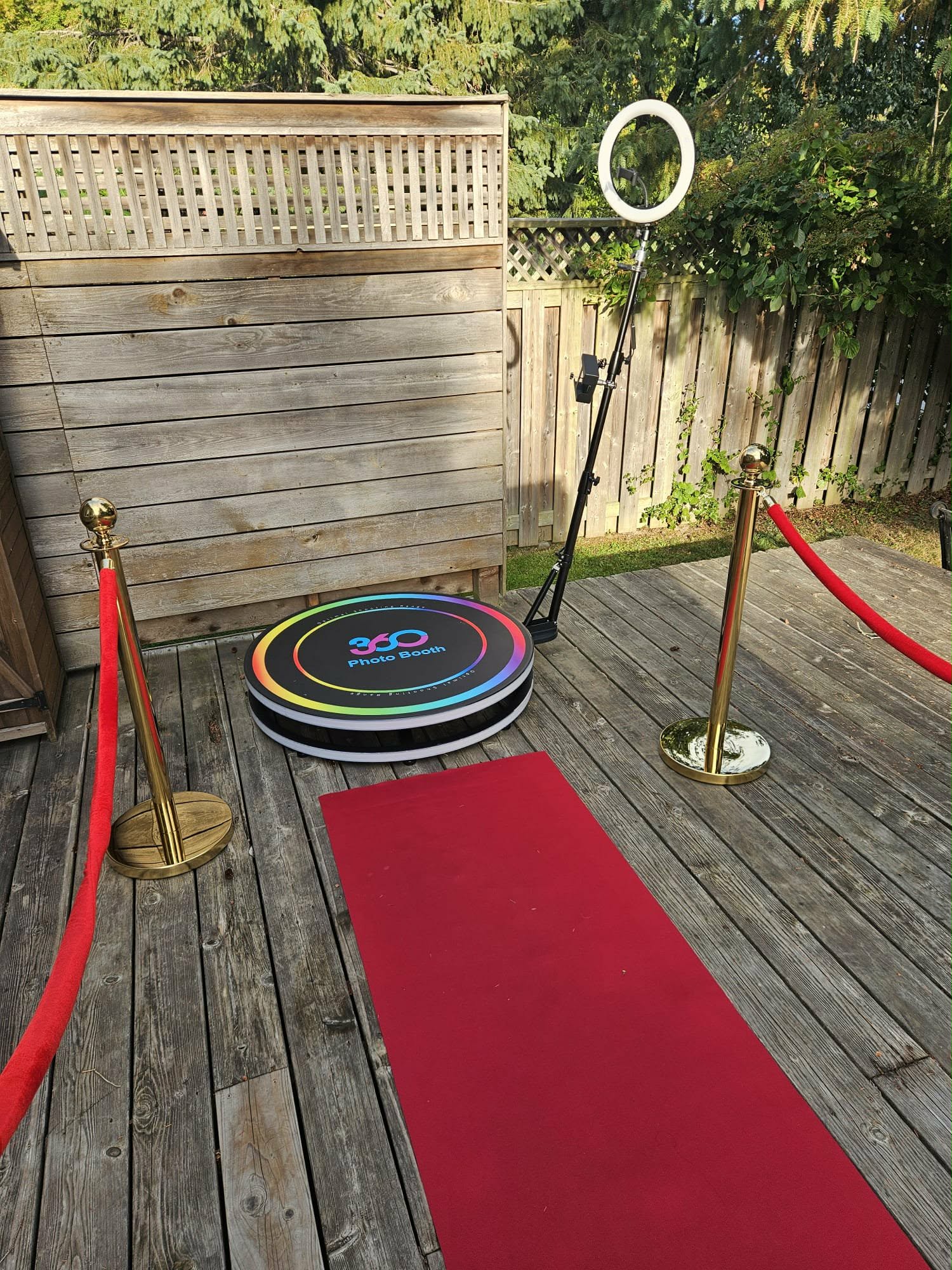 360 video booth platform with red carpet and stanchions on outdoor deck in Ottawa