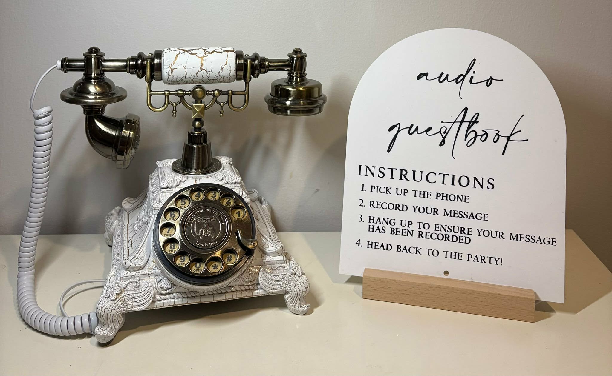 White vintage audio guestbook phone with sign for guests to leave messages