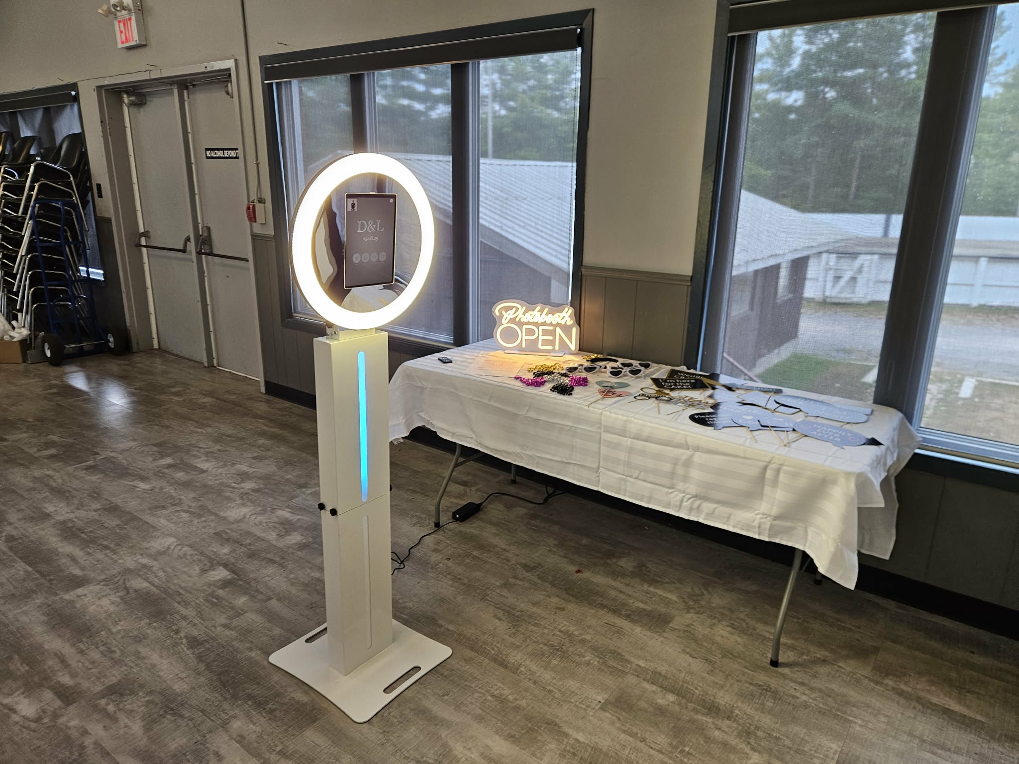 Standard photo booth with neon sign and props table at an Ottawa event venue